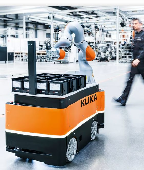 Industrial robot arm and mobile platform on a factory floor